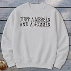 White sweatshirt with black text reading "JUST A MESSIN AND A GOMMIN."