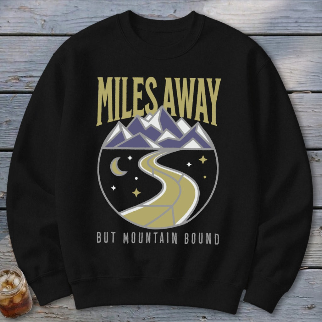 Black crewneck sweatshirt with "MILES AWAY BUT MOUNTAIN BOUND" and mountain graphic.