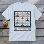 Light blue t-shirt with a "Flying Geese" quilt design and floral accents.