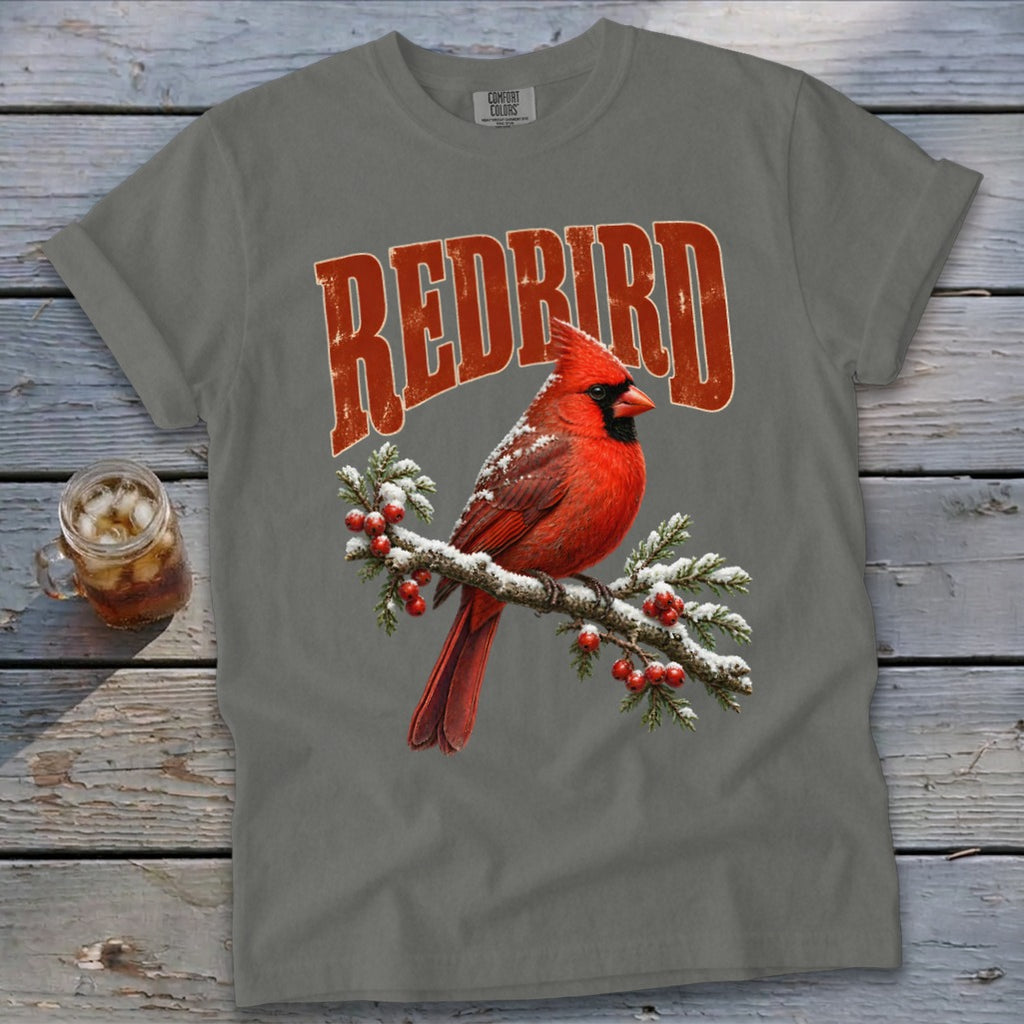 Grey t-shirt featuring a graphic of a red cardinal on a snowy branch with the text REDBIRD.