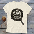 Cream t-shirt with a cast iron skillet graphic saying "No Sugar In The Cornbread."