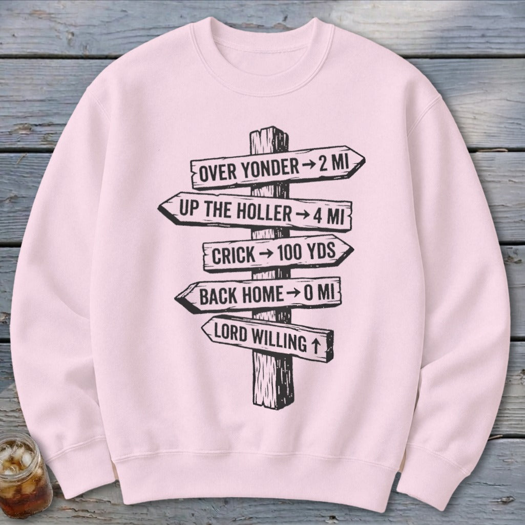 Light pink crewneck sweatshirt with a black graphic of a wooden post featuring directional distance signs.