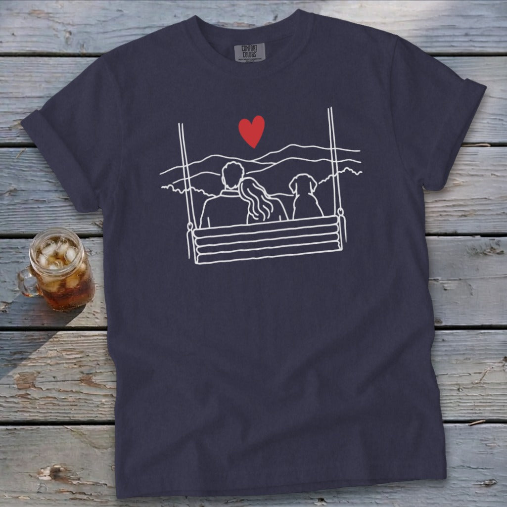 Navy t-shirt with white line art of couple and dog on swing, red heart.