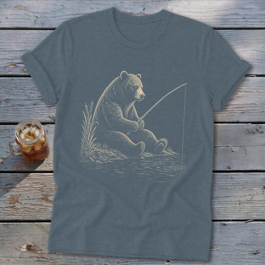 T-shirt with a graphic of a bear fishing by a lake at sunset.