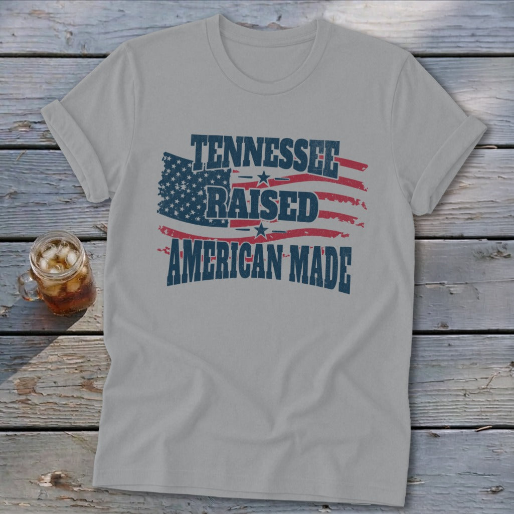 Grey t-shirt with "Tennessee Raised American Made" text and distressed American flag graphic.