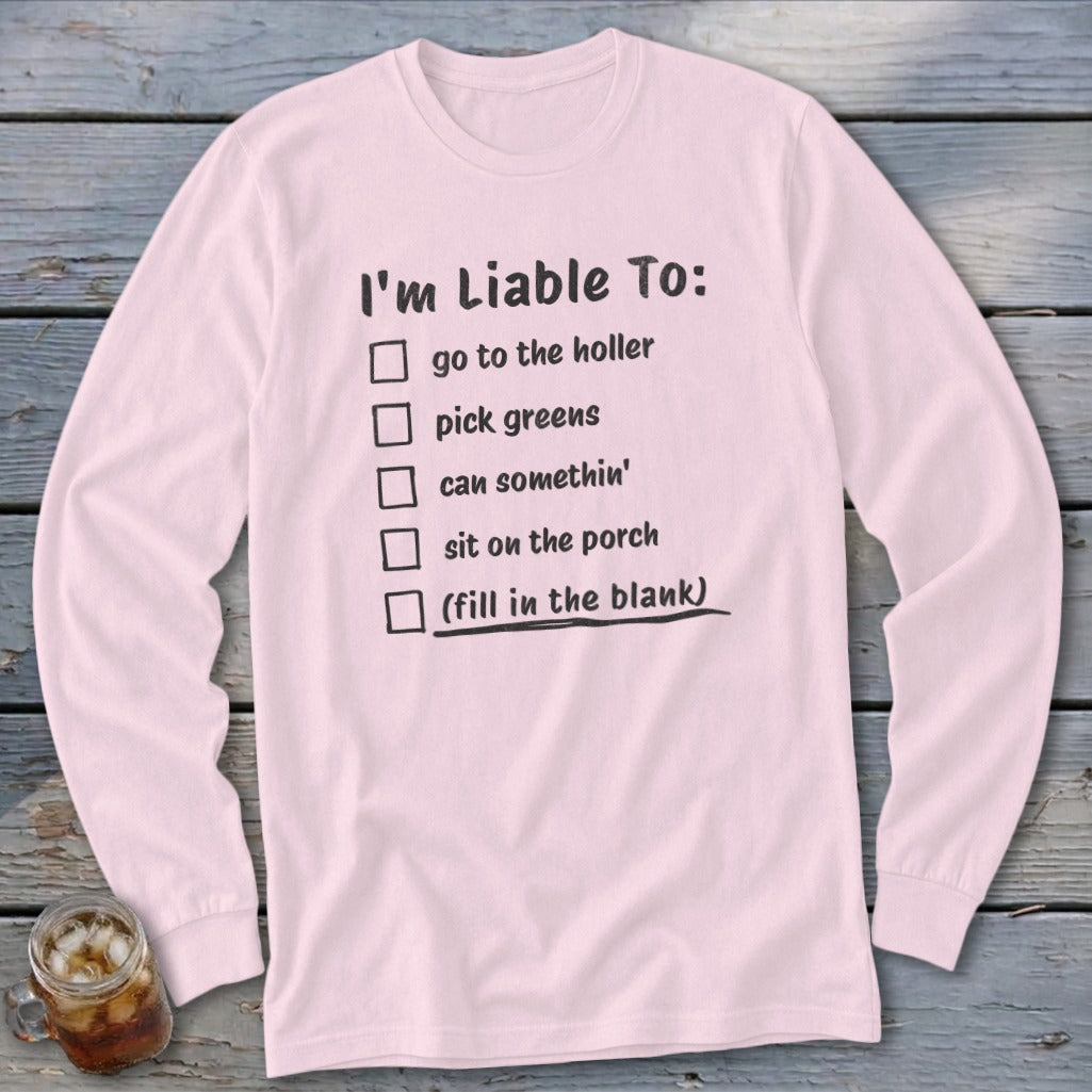 Pink long-sleeve shirt with text "I'm Liable To: go to the holler, pick greens, can somethin'".