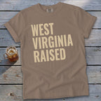 Brown t-shirt with "West Virginia Raised" printed in beige text.