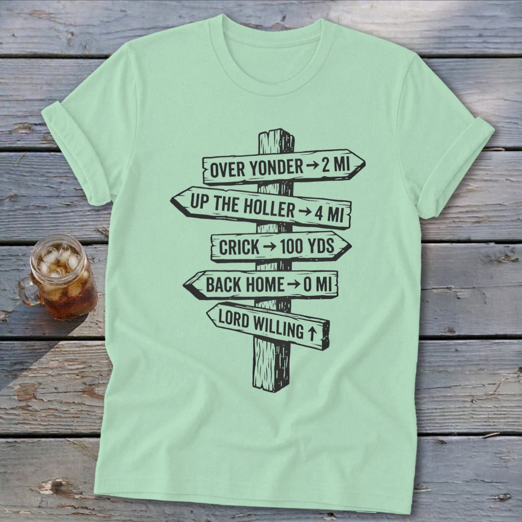 Mint green t-shirt featuring a black graphic of a wooden directional signpost with distances.