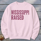 Light pink sweatshirt with "MISSISSIPPI RAISED" text in maroon.