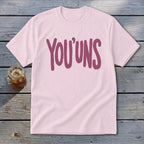 Light pink t-shirt with "YOU' UNS" in maroon text.