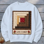 White sweatshirt with a quilted log cabin design and "LOG CABIN" text.