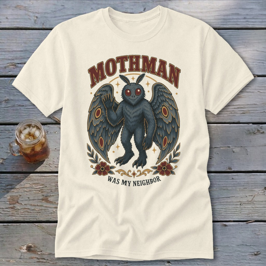 Mothman graphic with wings and text "Mothman Was My Neighbor" on a cream t-shirt.