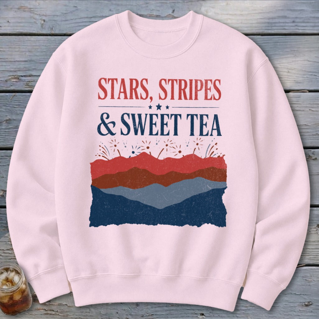 A light pink crewneck sweatshirt features distressed patriotic graphics and the text STARS STRIPES SWEET TEA.
