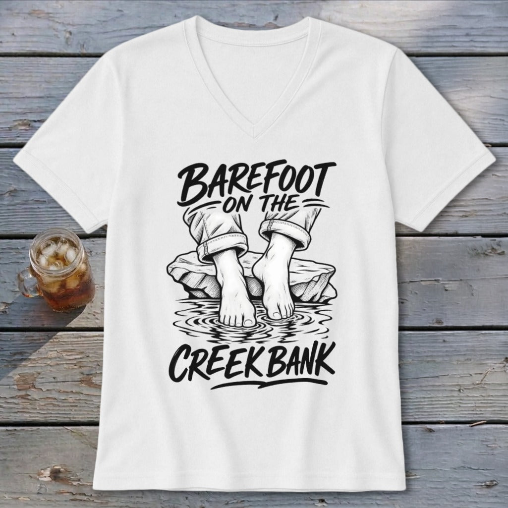 White v-neck t-shirt with "BAREFOOT ON THE CREEK BANK" graphic.