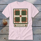 Pink t-shirt with a green and red "Bear's Paw" quilt pattern graphic.