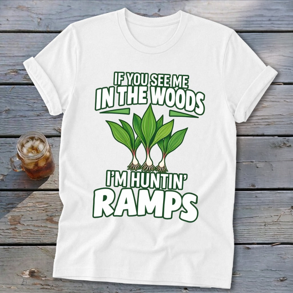 A white t-shirt featuring green text that reads If You See Me in the Woods I'm Huntin' Ramps and an illustration of ramps.