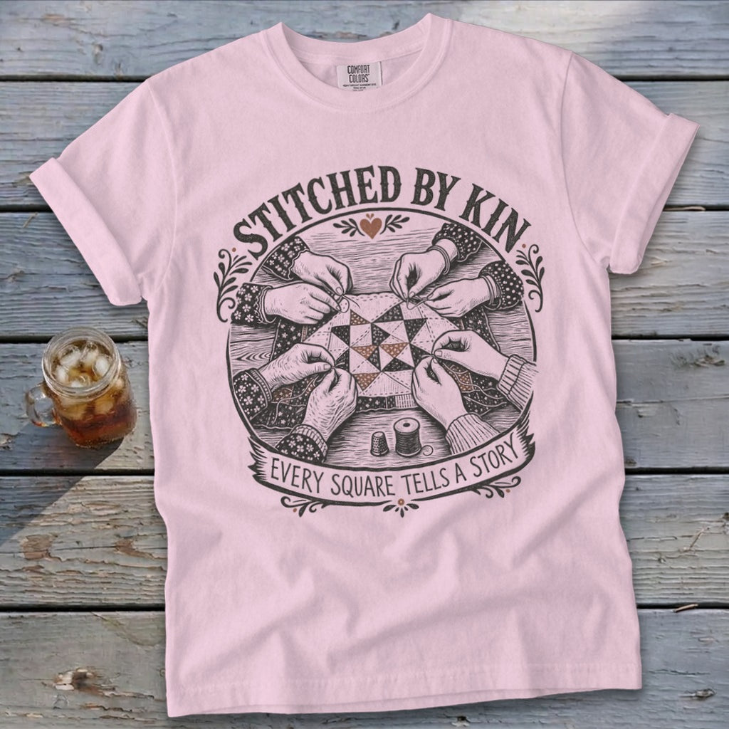 Pink t-shirt with stitched by kin Every square tells a story graphic.