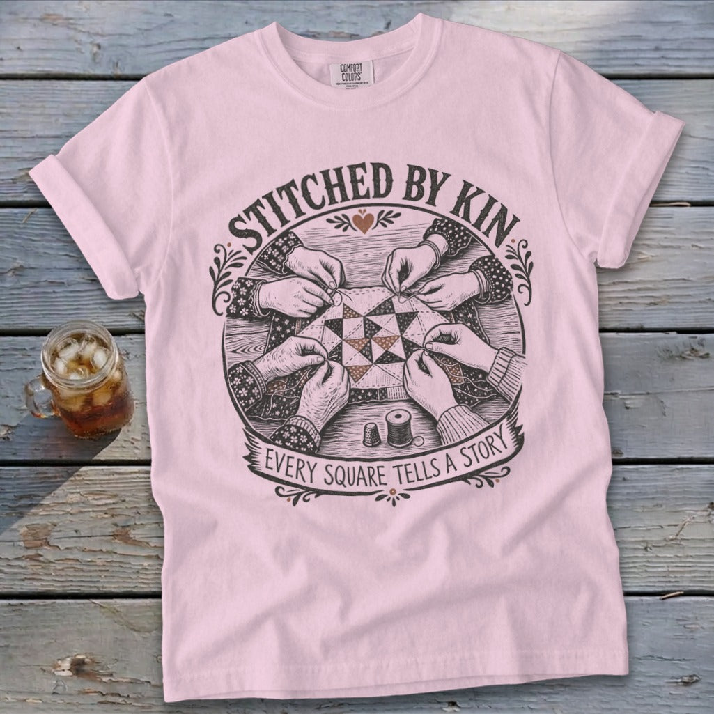Pink t-shirt with stitched by kin Every square tells a story graphic.