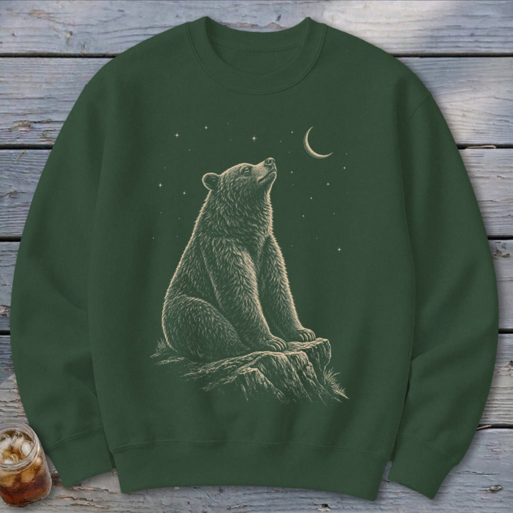 Green sweatshirt with a stylized illustration of a bear sitting on a rock under a starry night sky.