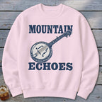 Light pink crewneck sweatshirt featuring a blue graphic of a banjo and the text Mountain Echoes.