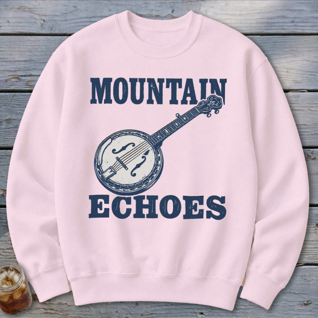Light pink crewneck sweatshirt featuring a blue graphic of a banjo and the text Mountain Echoes.