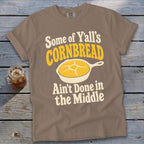 Brown t-shirt featuring the text "Some of Y'all's Cornbread Ain't Done in the Middle" and a cast-iron skillet graphic.