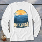 A white long-sleeved t-shirt featuring a retro graphic of mountains, pine trees, a setting sun, and the text Over Yonder.