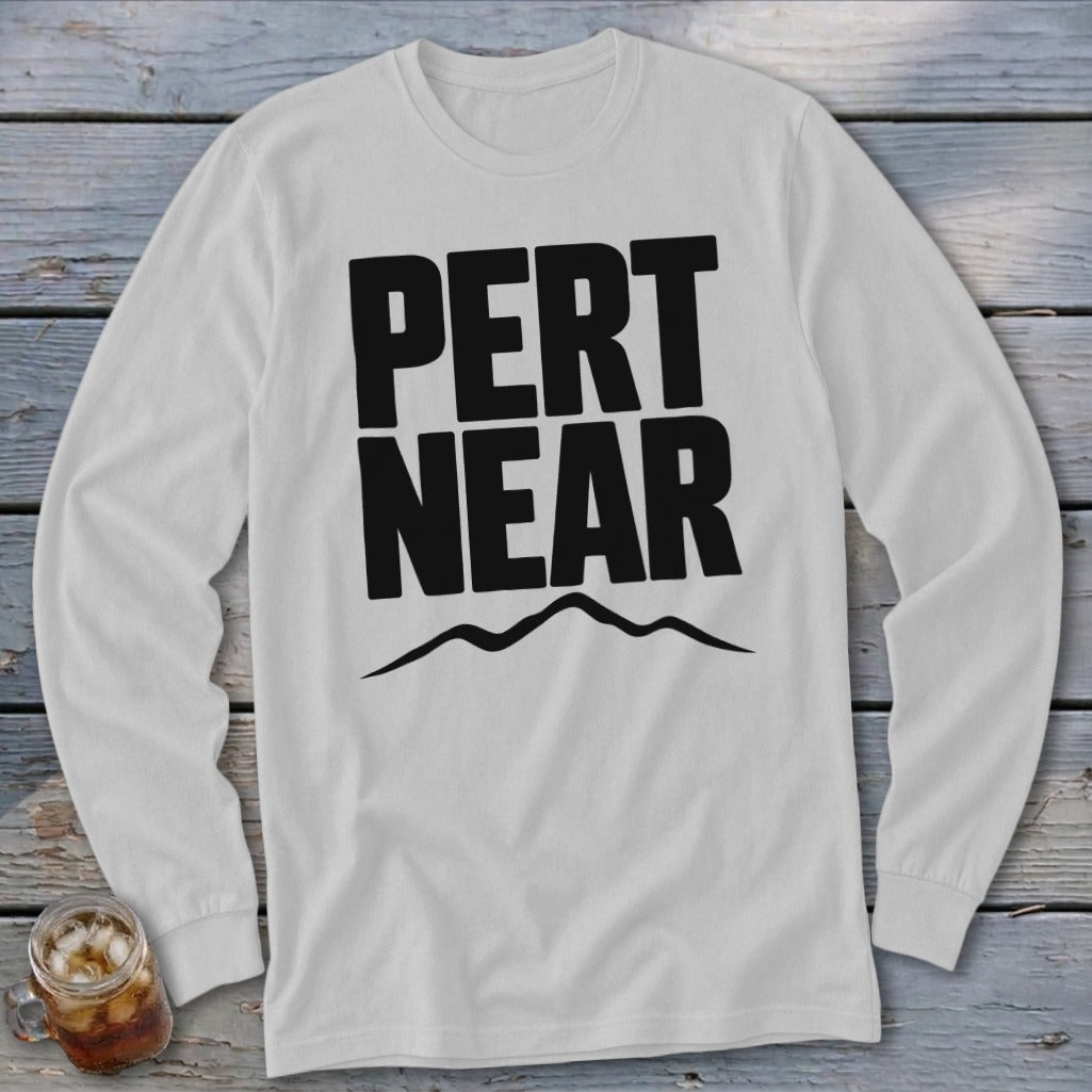 Light grey long-sleeve t-shirt with black block lettering reading "PERT NEAR" above a mountain outline.