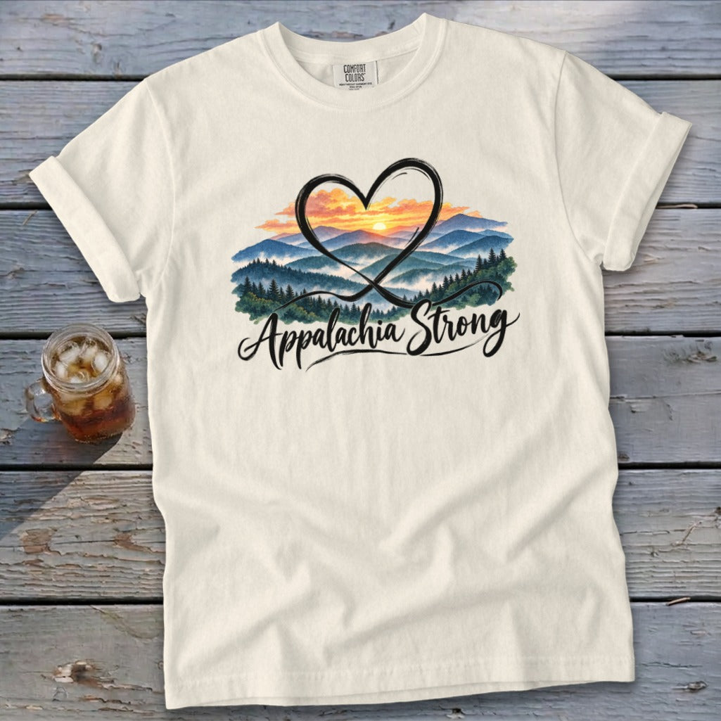 Cream t-shirt with heart framing a mountain sunrise and "Appalachia Strong" text.