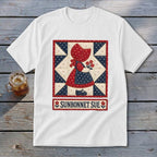 White t-shirt featuring a Sunbonnet Sue quilt design with flowers and text.