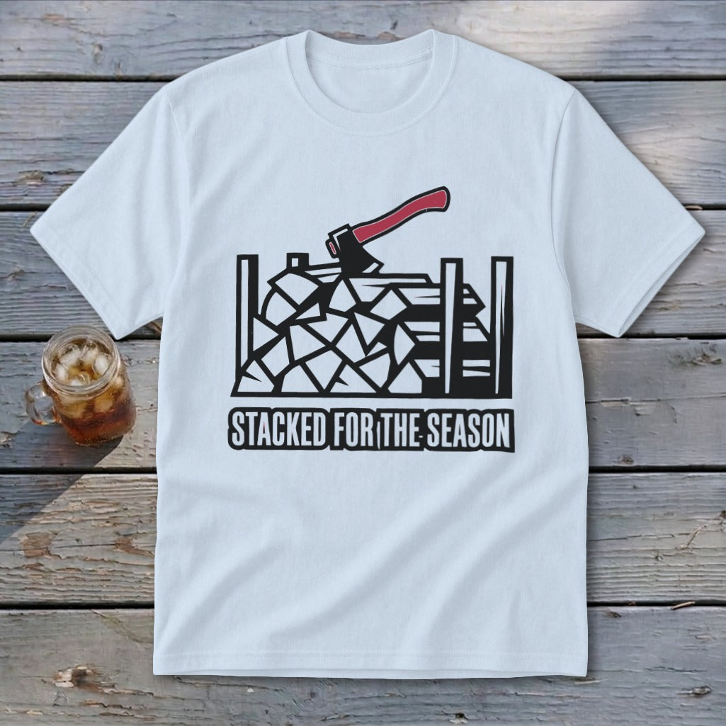 White t-shirt graphic of stacked firewood with axe and text "STACKED FOR THE SEASON".