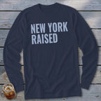 Navy long sleeve shirt with "NEW YORK RAISED" in light blue text.
