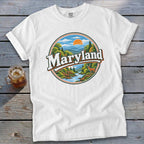 White t-shirt with a circular Maryland graphic featuring a river, mountains, deer, and trees.