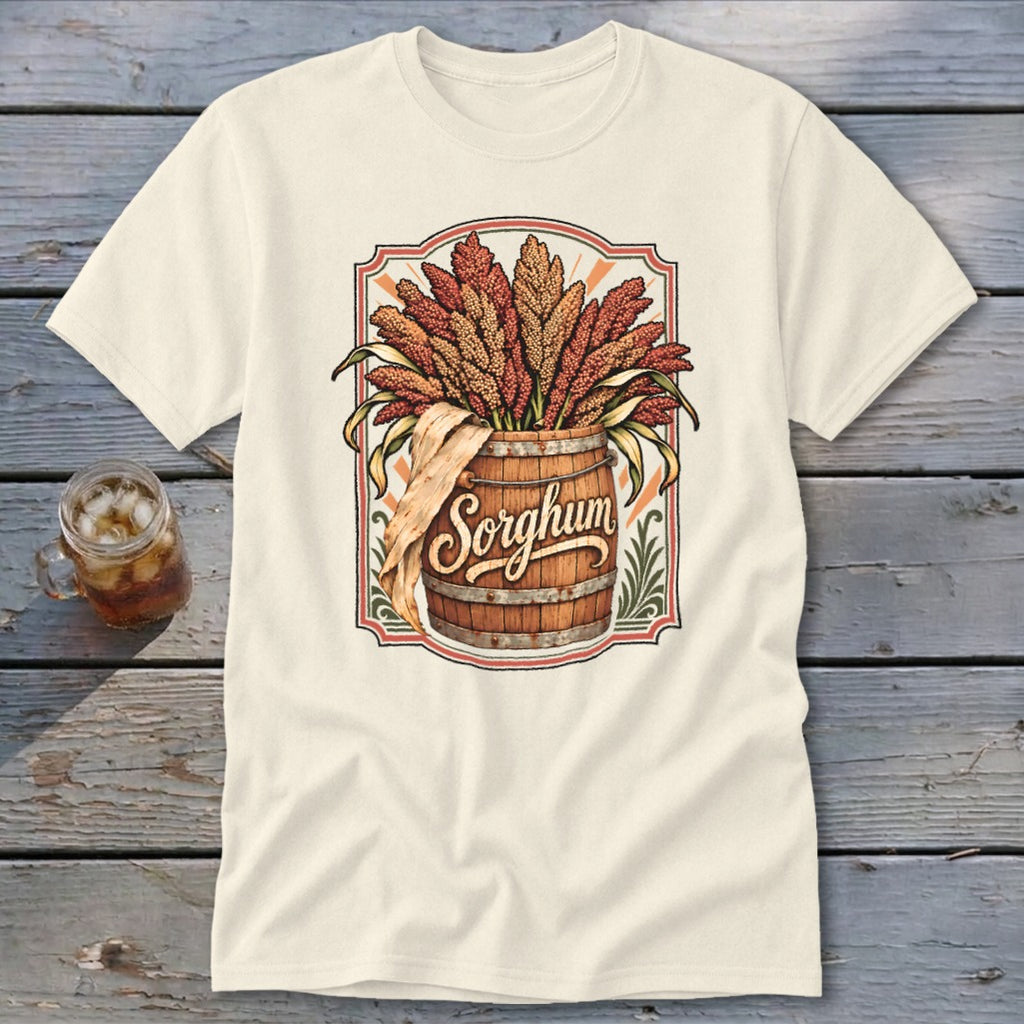 Cream t-shirt featuring a wooden barrel overflowing with sorghum stalks and the word "Sorghum."