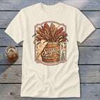 Cream t-shirt featuring a wooden barrel overflowing with sorghum stalks and the word "Sorghum."