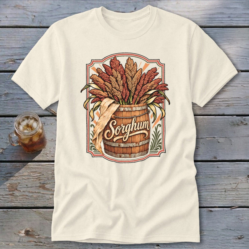 Cream t-shirt featuring a wooden barrel overflowing with sorghum stalks and the word "Sorghum."