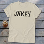 Cream t-shirt with "LOOKING A LITTLE JAKEY" text and a drink in a mason jar.