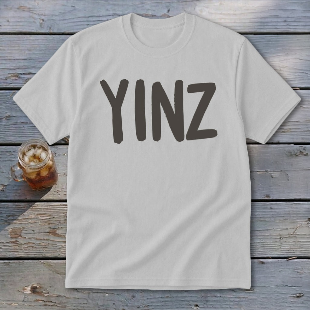 White t-shirt with dark gray "YINZ" text, and a glass of iced beverage.