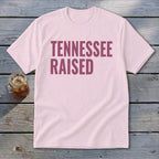 Light pink t-shirt with "TENNESSEE RAISED" text in maroon.