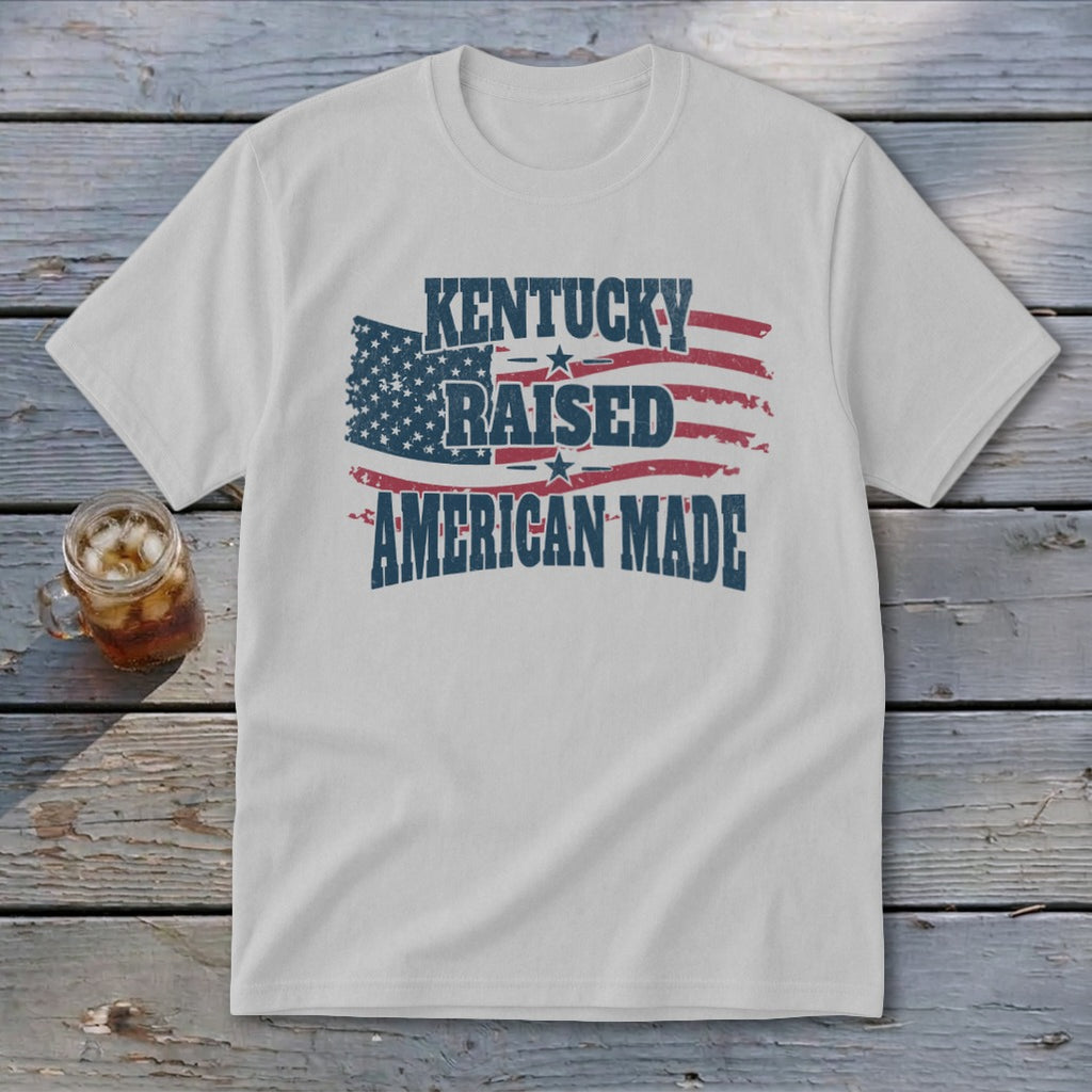 White t-shirt with American flag graphic and text "KENTUCKY RAISED AMERICAN MADE".