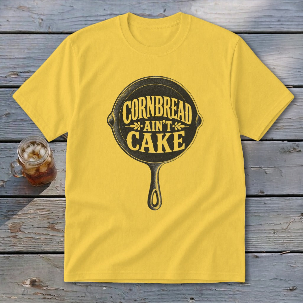 Yellow t-shirt with "Cornbread Ain't Cake" text in a cast iron skillet graphic.