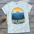 A light blue t-shirt with a retro mountain sunrise graphic and the text Over Yonder.