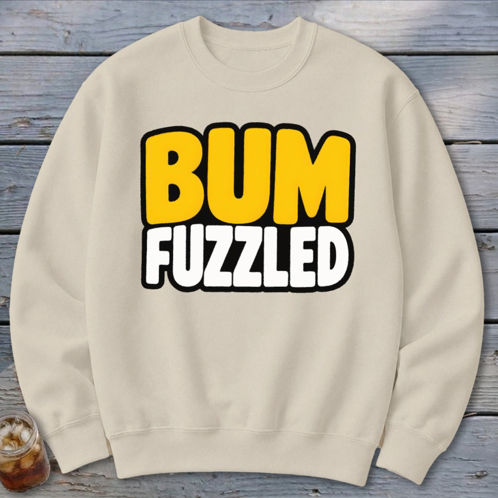 Beige crewneck sweatshirt featuring the text BUM FUZZLED in bold yellow and white letters.