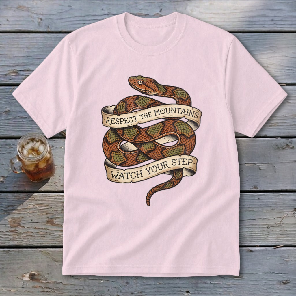 Pink t-shirt with a coiled snake graphic and banners reading "Respect The Mountains" and "Watch Your Step".