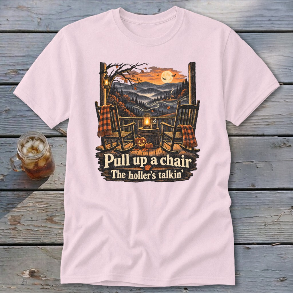 Light pink t-shirt with rocking chairs on a porch, saying "Pull up a chair. The holler's talkin'."