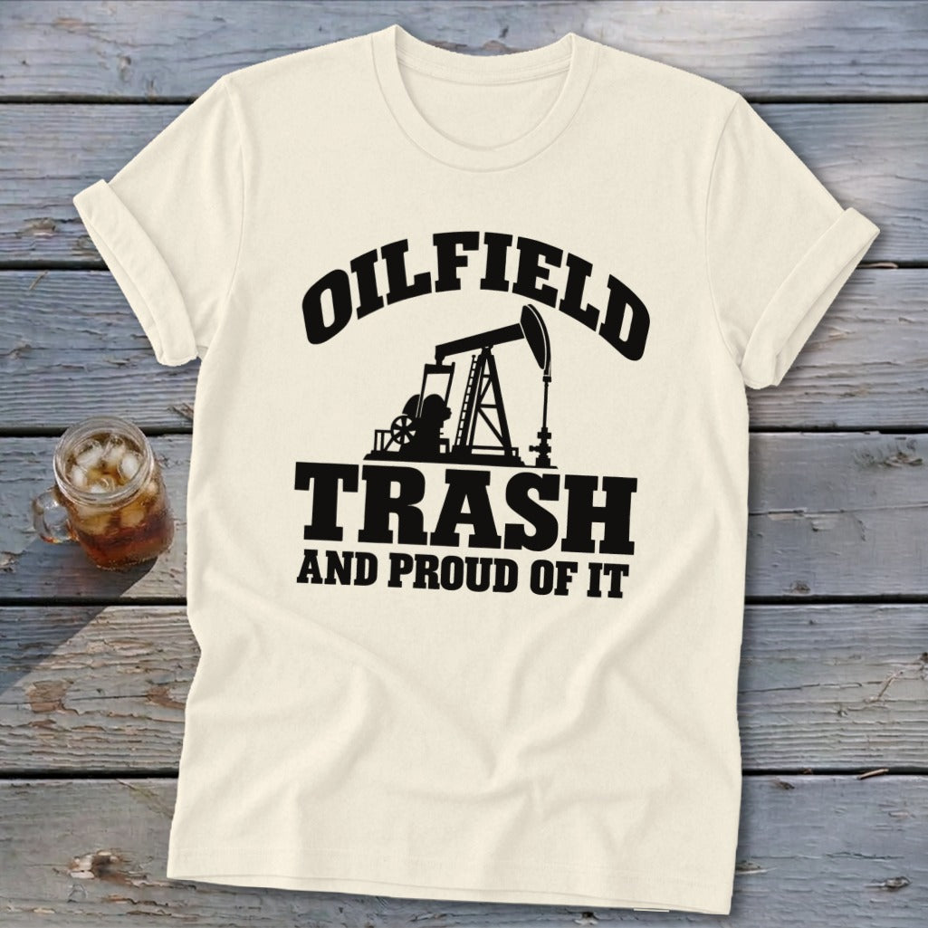 Cream t-shirt with black text and oil derrick graphic reading "Oilfield Trash and Proud of It".