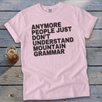 Pink t-shirt with black text reading "Anymore people just don't understand mountain grammar".