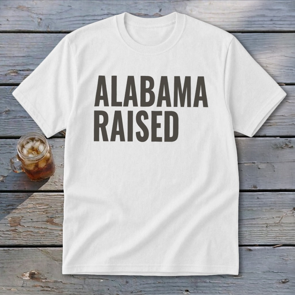 White t-shirt with "ALABAMA RAISED" printed in bold dark gray letters.