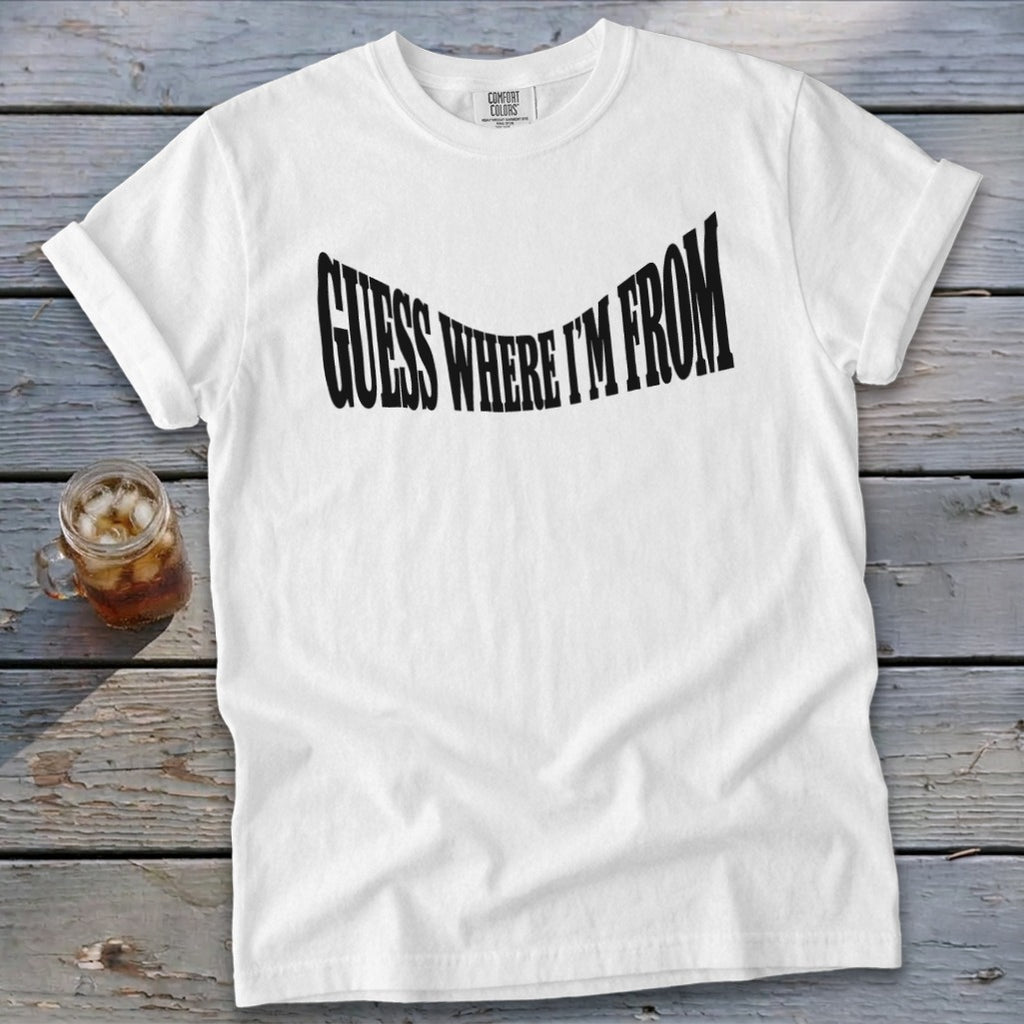 White t-shirt with black text reading "GUESS WHERE I'M FROM"