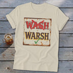 Cream-colored t-shirt with a distressed graphic of a rustic sign reading WASH with a red X and WARSH with a green checkmark.